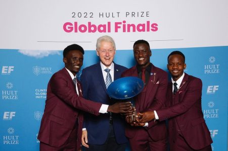 The Eco-Bana team pictured with their trophy and former United States President Bill Clinton. Photo credit: Lennox Omondi, Eco-Bana CEO and Co-Founder